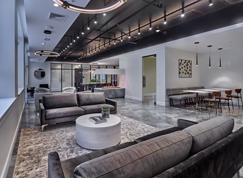 A modern living room with a grey sofa set and a coffee table.